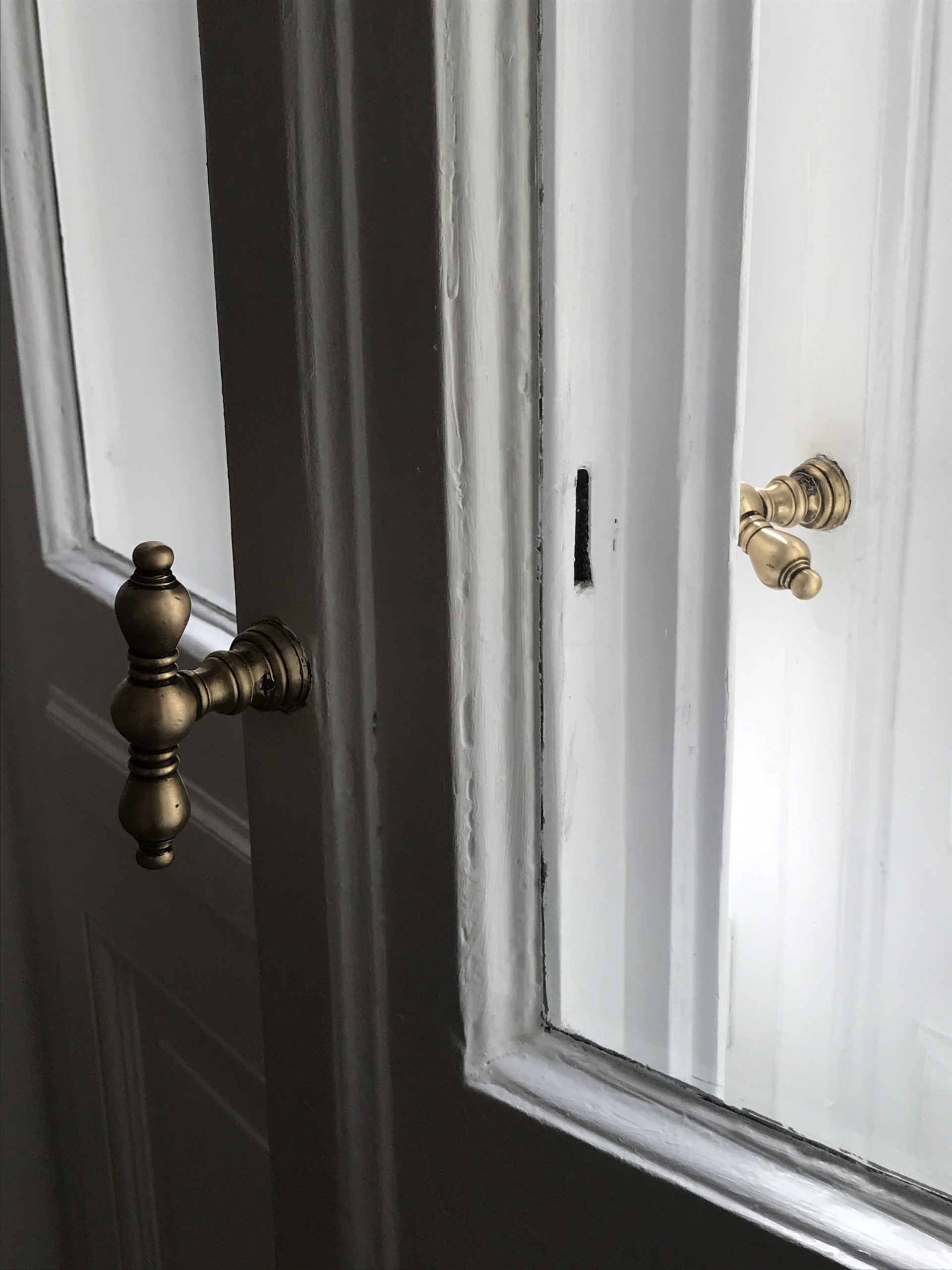 vintage gold door handles, european interior design inspo, historic building, white french doors | RG Daily Blog