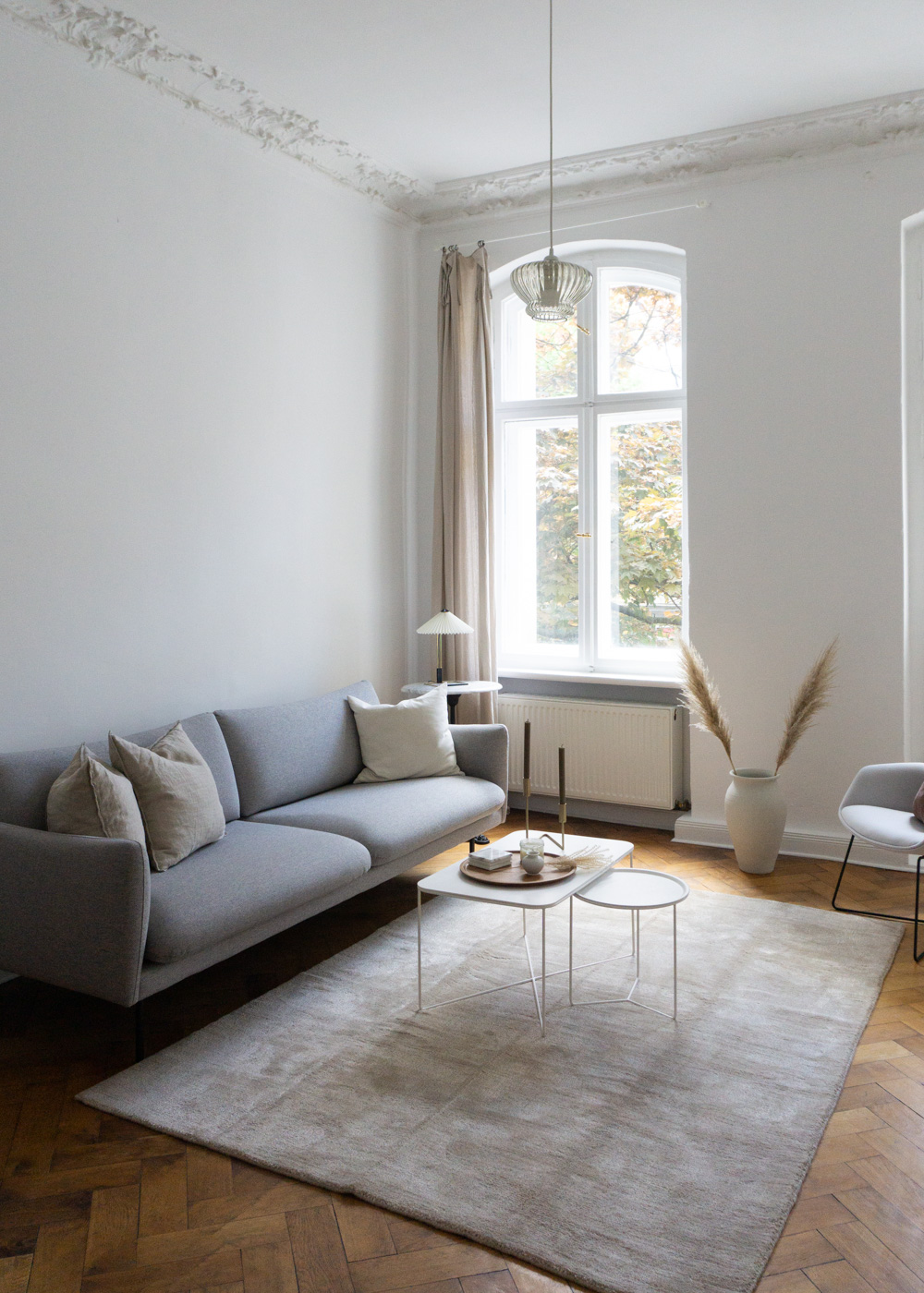 Grey Sofa, Toupe Rug, White Living Room, Wood Floors - Neutral Home, Scandinavian Aesthetic, Berlin Apartment, White Interior, Calm Lighting | RG Daily Blog